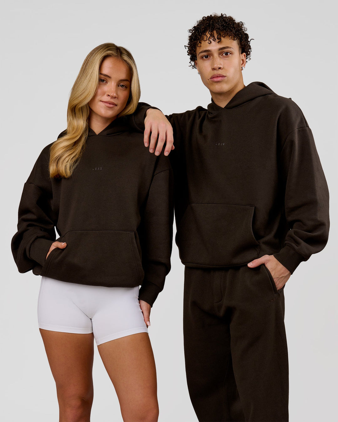 Duo wearing Base Oversized Hoodie - Ground Coffee | Model:Issy | Size:XS | Model:Leandro | Size:M - view 1