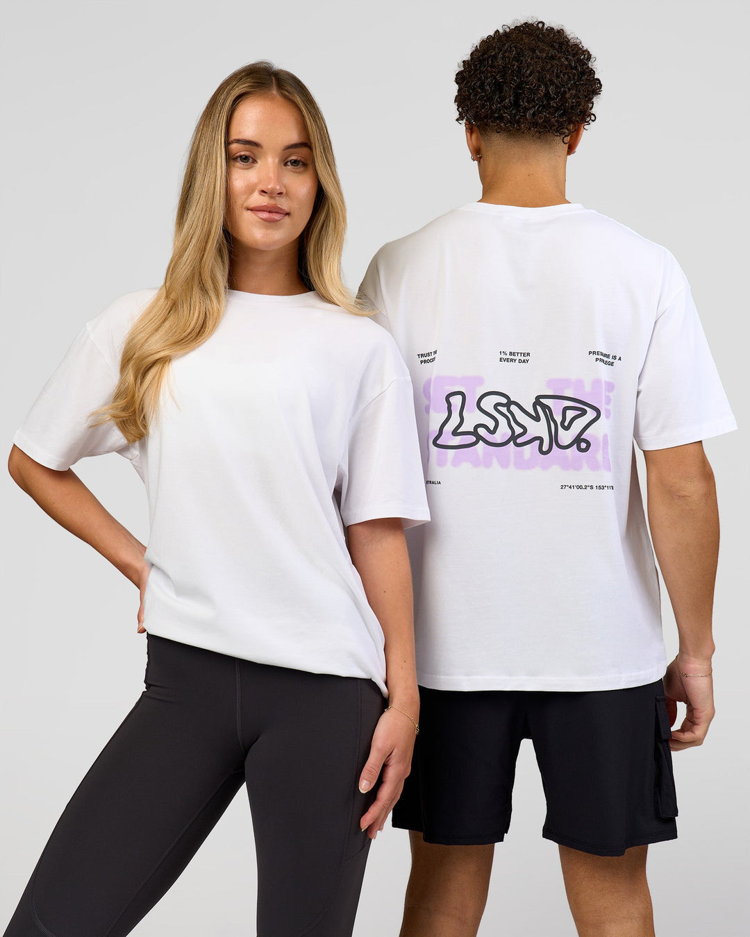 Duo wearing Benchmark FLXCotton Oversized Tee - White-Pale Lilac | Model:Issy | Size:XS | Model:Leandro | Size:M - view 1