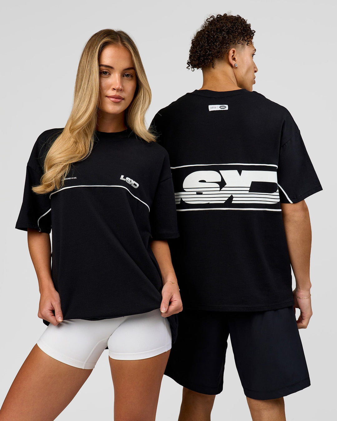 Duo wearing Inline Heavyweight FLXCotton Oversized Tee - Black-White | Model:Issy | Size:XS | Model:Leandro | Size:M - view 1