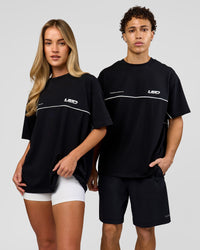Duo wearing Inline Heavyweight FLXCotton Oversized Tee - Black-White | Model:Issy | Size:XS | Model:Leandro | Size:M | Thumbnail Index: 1