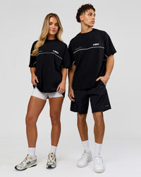 Duo wearing Inline Heavyweight FLXCotton Oversized Tee - Black-White | Model:Issy | Size:XS | Model:Leandro | Size:M | Thumbnail Index: 2