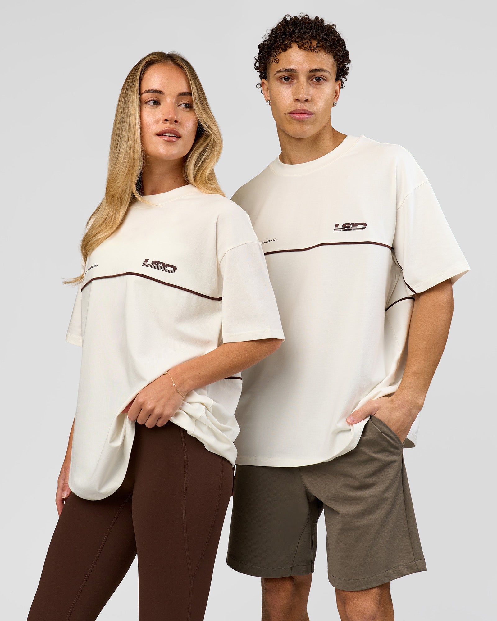 Duo wearing Inline Heavyweight FLXCotton Oversized Tee - Off White-Hot Chocolate | Model:Issy | Size:XS | Model:Leandro | Size:M