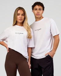 Duo wearing VS1 Enjoy The Journey FLXCotton Oversize Tee - White | Model:Issy | Size:XS | Model:Leandro | Size:M | Thumbnail Index: 0