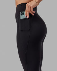 Woman wearing O.G. Fusion Ultra High-Rise Tall Legging Pockets - Black | Model:Bree | Size:S