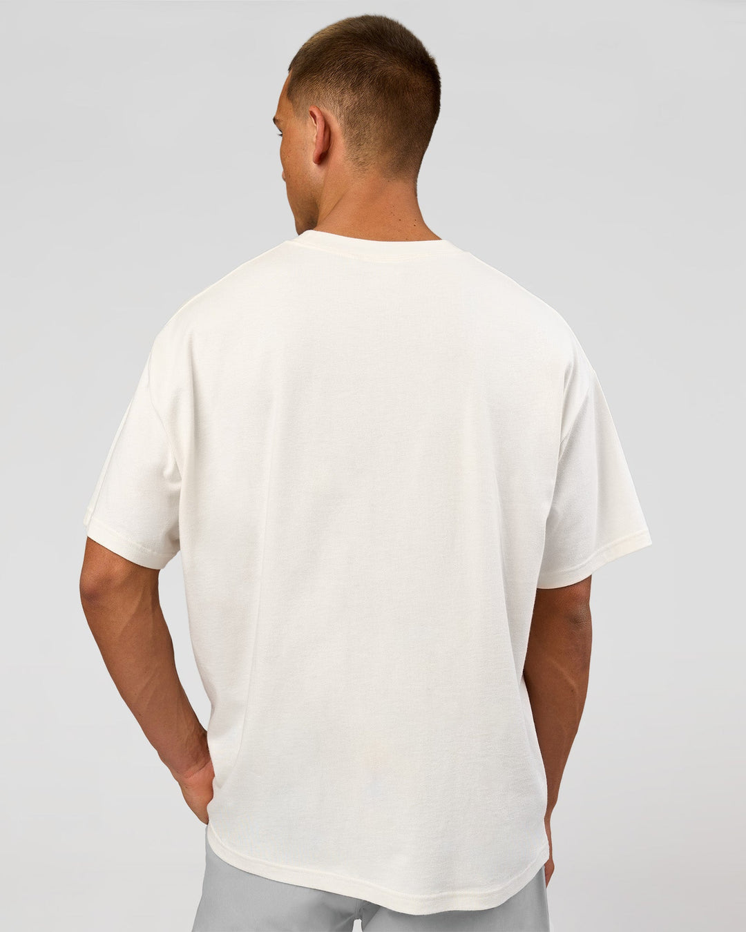 Man wearing Varsity EST Heavyweight Oversized Tee  - Off White-Future Navy | Model:Albert | Size:L - view 10