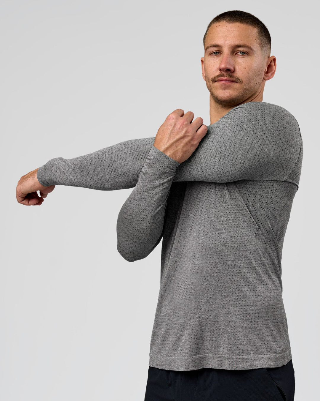 Man wearing AeroFLX+ Seamless Long Sleeve Tee (Set in Sleeve) - Dark Storm/Alloy | Model:Jaiden | Size:L - view 1