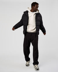 Man wearing Base Puffer Jacket - Black | Model:Okello | Size:L | Thumbnail Index: 12