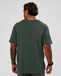 Man wearing Base FLXCotton Tee Oversized - Midnight Green Washed | Model:Xav | Size:L | Thumbnail Index: 2