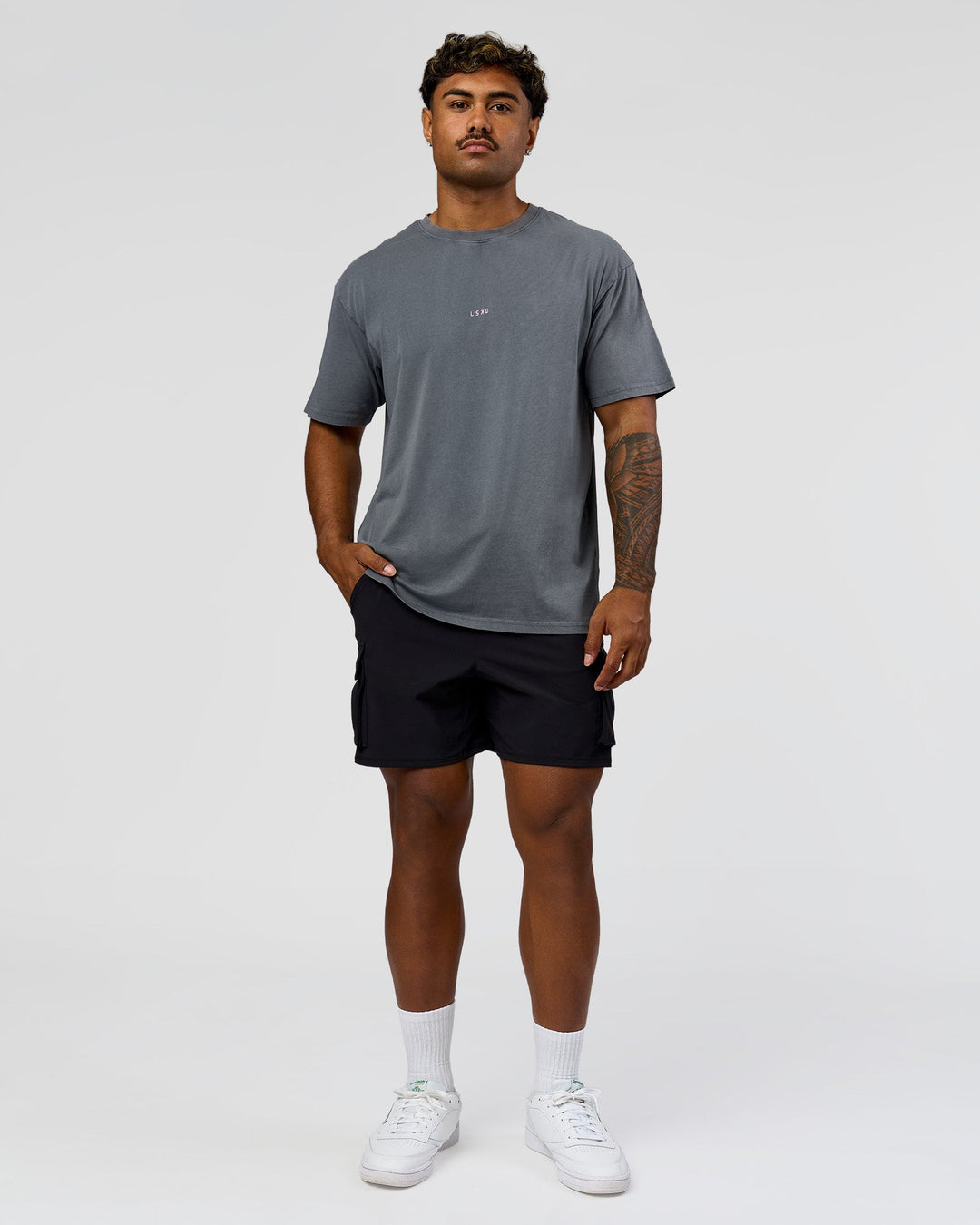 Man wearing Built On Values FLXCotton Oversized Tee - Dark Storm Washed-Pink Rose | Model:Xav | Size:L