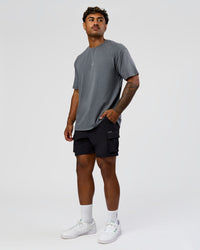 Man wearing Built On Values FLXCotton Oversized Tee - Dark Storm Washed-Pink Rose | Model:Xav | Size:L