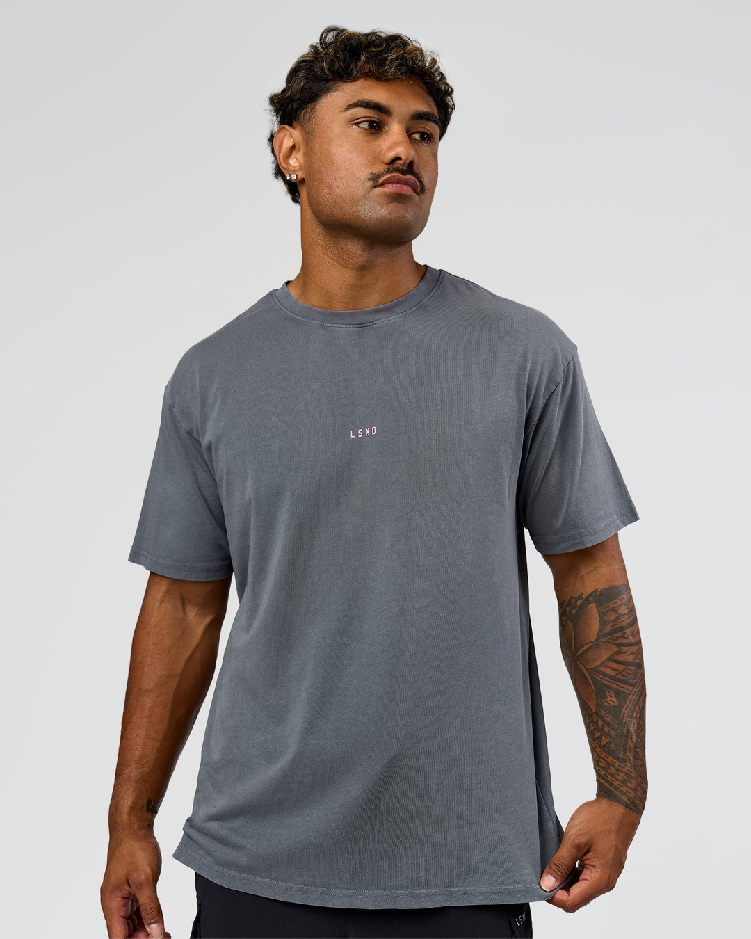 Man wearing Built On Values FLXCotton Oversized Tee - Dark Storm Washed-Pink Rose | Model:Xav | Size:L