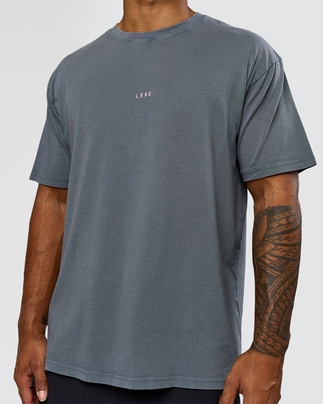 Man wearing Built On Values FLXCotton Oversized Tee - Dark Storm Washed-Pink Rose | Model:Xav | Size:L