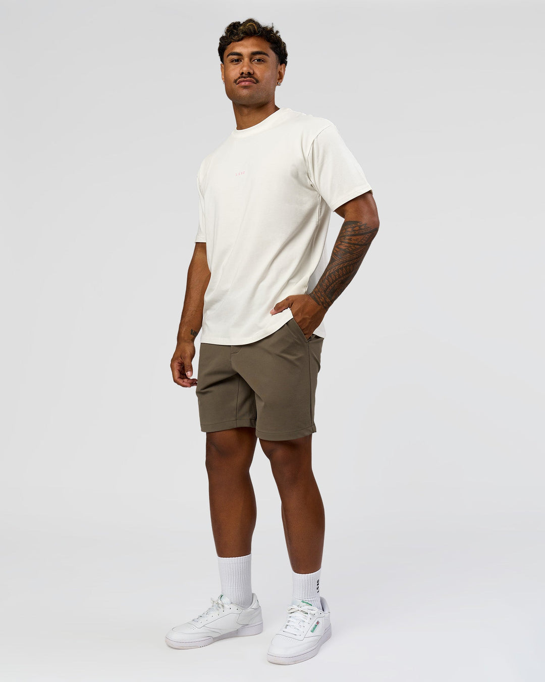 Man wearing Built On Values FLXCotton Oversized Tee - Off White-Pink Rose | Model:Xav | Size:L