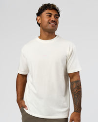 Man wearing Built On Values FLXCotton Oversized Tee - Off White-Pink Rose | Model:Xav | Size:L