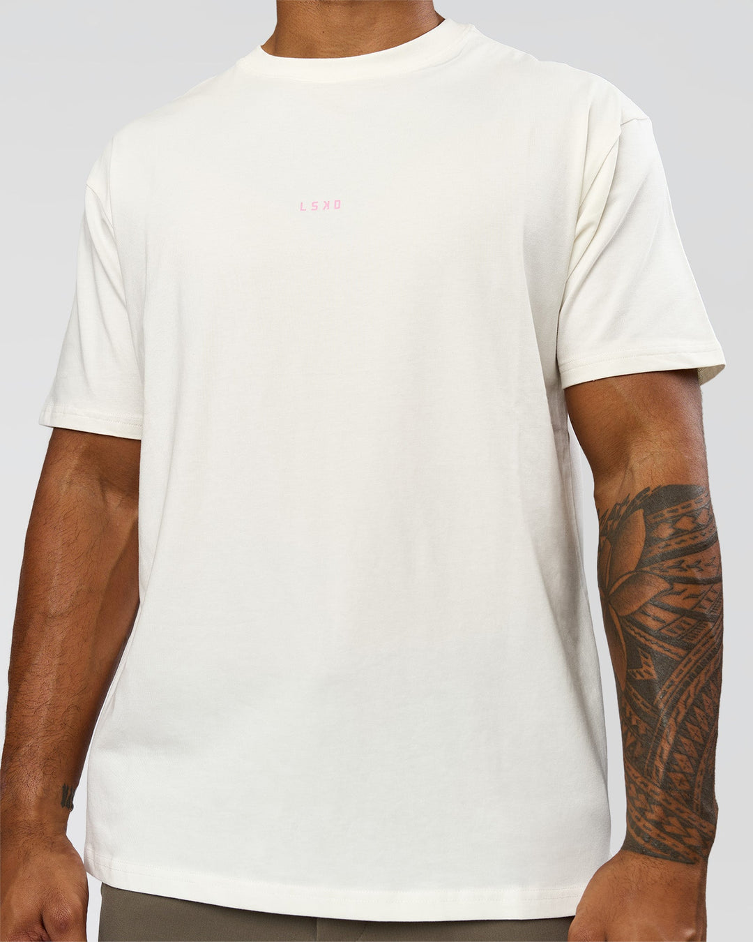 Man wearing Built On Values FLXCotton Oversized Tee - Off White-Pink Rose | Model:Xav | Size:L