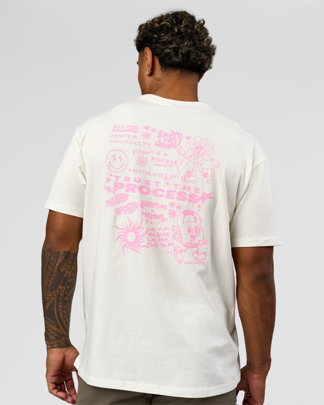 Man wearing Built On Values FLXCotton Oversized Tee - Off White-Pink Rose | Model:Xav | Size:L