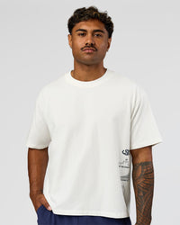Man wearing Greatest of All Time Heavyweight FLXCotton Boxed Tee - Off White Washed | Model:Xav | Size:L | Thumbnail Index: 6