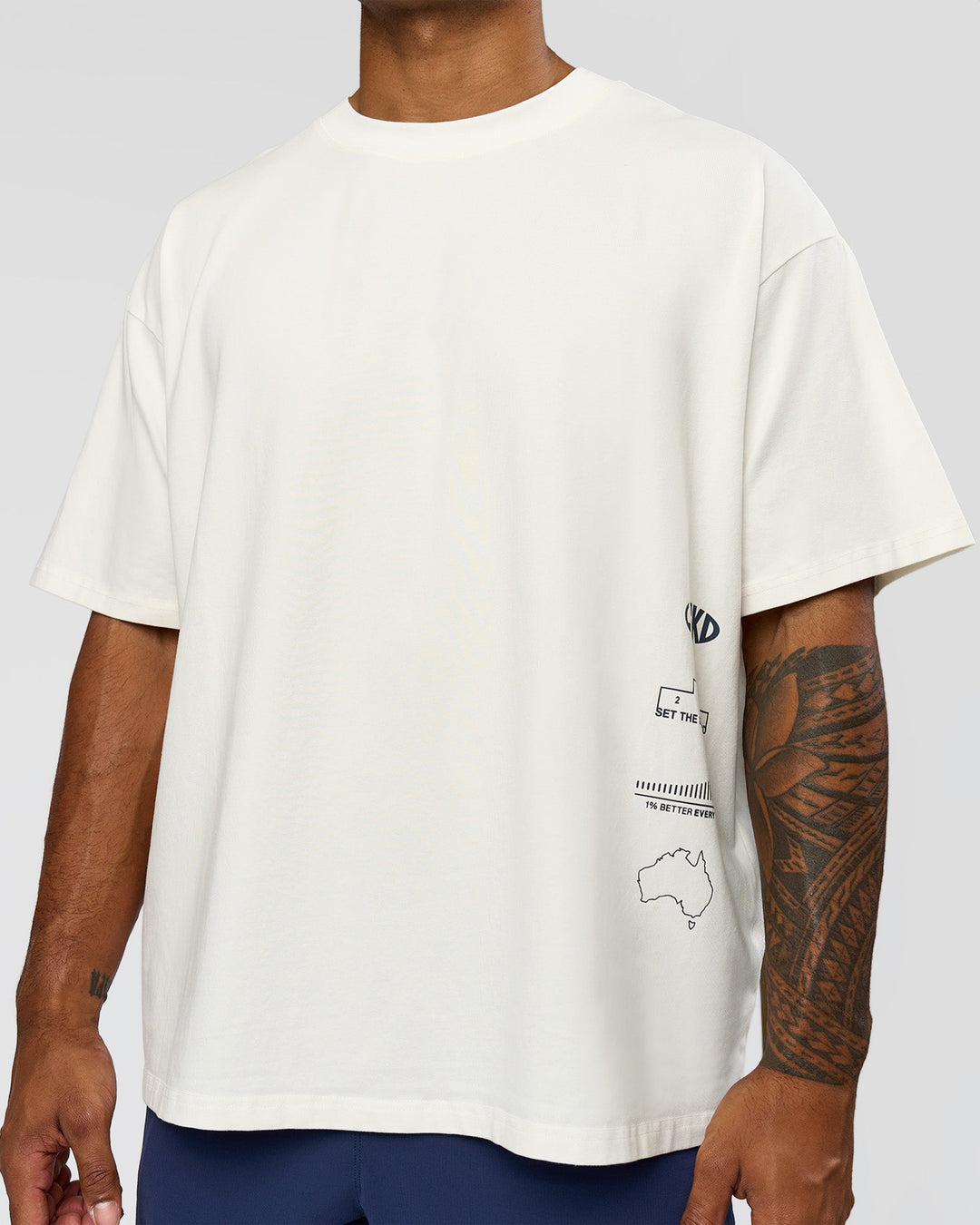 Man wearing Greatest of All Time Heavyweight FLXCotton Oversized Tee - Off White Washed-Scarlet | Model:Xav | Size:L - view 5