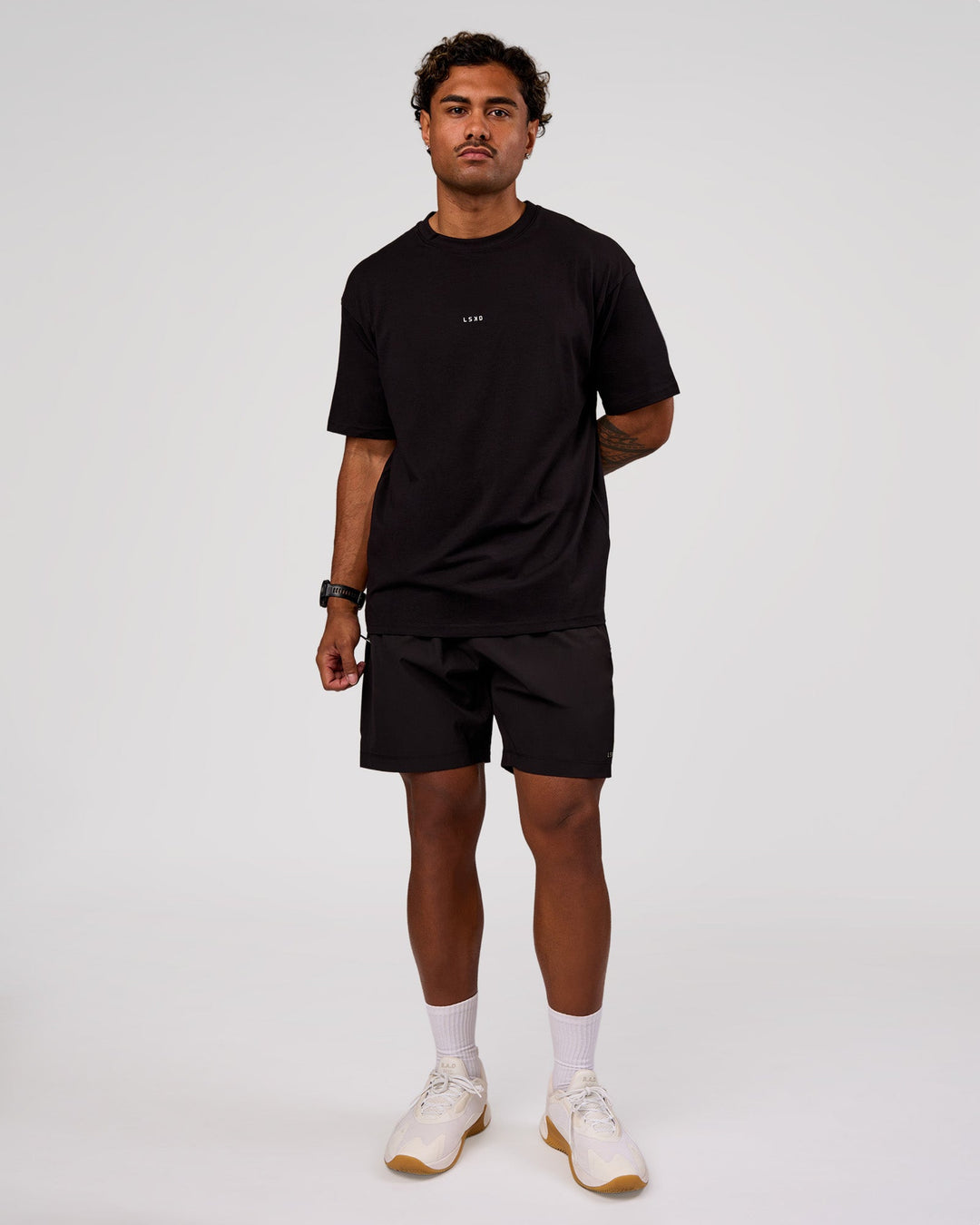 Man wearing Rep 7" Performance Short - Black-White | Model:Xav | Size:L - view 3