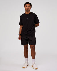 Man wearing Rep 7" Performance Short - Black-White | Model:Xav | Size:L | Thumbnail Index: 2