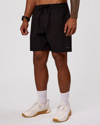Man wearing Rep 7" Performance Short - Black-White | Model:Xav | Size:L | Thumbnail Index: 4