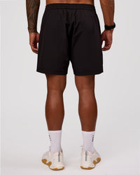 Man wearing Rep 7" Performance Short - Black-White | Model:Xav | Size:L | Thumbnail Index: 5