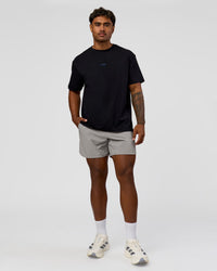 Man wearing Run Club Elevate FLXCotton Oversized Tee - Black-Electric Indigo | Model:Xav | Size:L