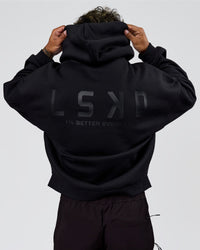 Man wearing Tonal Legacy Boxy Hoodie - Black-Black | Model:Xav | Size:L | Thumbnail Index: 1