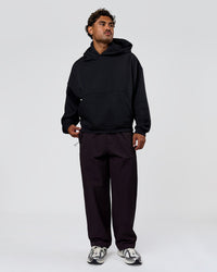 Man wearing Tonal Legacy Boxy Hoodie - Black-Black | Model:Xav | Size:L | Thumbnail Index: 7