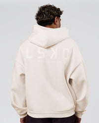 Man wearing Tonal Legacy Boxy Hoodie - Off White-Off White | Model:Xav | Size:L | Thumbnail Index: 1