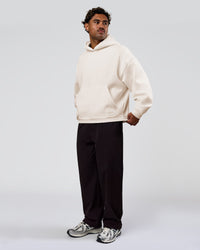 Man wearing Tonal Legacy Boxy Hoodie - Off White-Off White | Model:Xav | Size:L | Thumbnail Index: 10