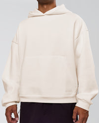 Man wearing Tonal Legacy Boxy Hoodie - Off White-Off White | Model:Xav | Size:L | Thumbnail Index: 12
