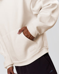 Man wearing Tonal Legacy Boxy Hoodie - Off White-Off White | Model:Xav | Size:L | Thumbnail Index: 14
