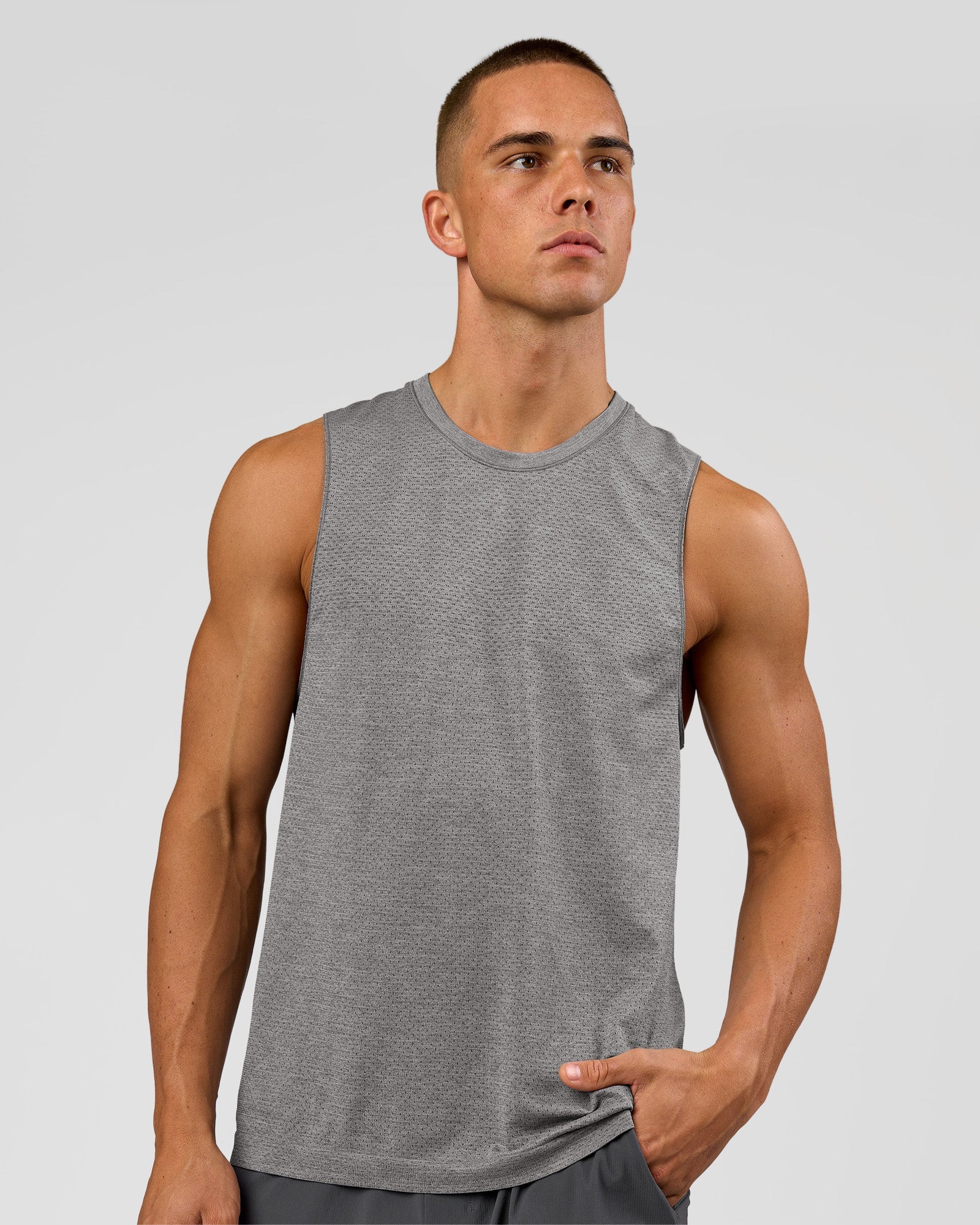 Man wearing AeroFLX+ Seamless Muscle Tank - Dark Storm/Alloy | Model:Albert | Size:M