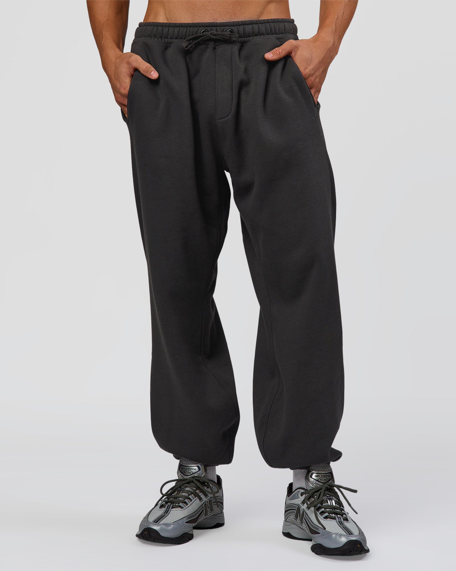 Man wearing Base Baggy Cuffed Track Pant - Onyx | Model:Albert | Size:M