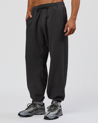 Man wearing Base Baggy Cuffed Track Pant - Onyx | Model:Albert | Size:M | Thumbnail Index: 0