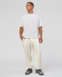 Man wearing Base Baggy Cuffed Track Pant - Silver Marl | Model:Albert | Size:M | Thumbnail Index: 1
