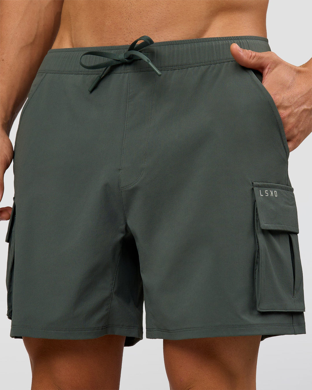 Man wearing Functional Cargo 6" Short - Carbon Green | Model:Albert | Size:M - view 1