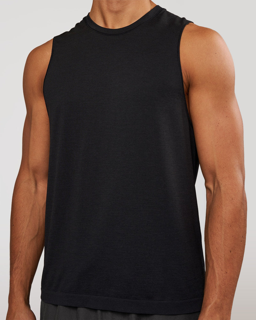Man wearing AeroFLX+ Seamless Muscle Tank - Black Marl | Model:Albert | Size:M - view 3