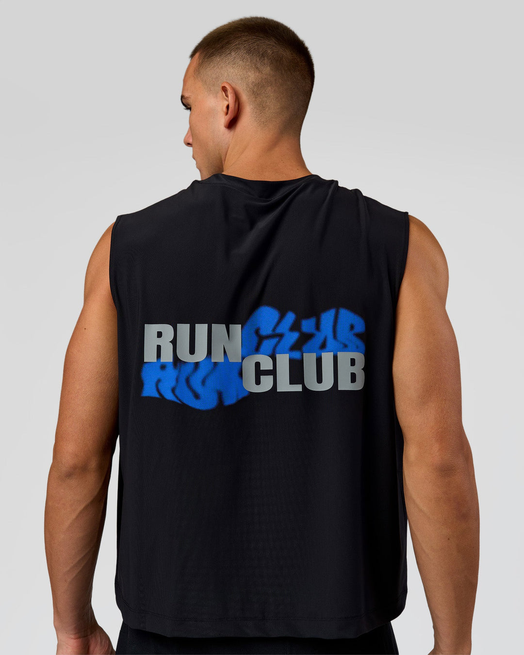 Man wearing Run Club Elevate Muscle Tank - Black-Electric Indigo | Model:Albert | Size:M - view 1