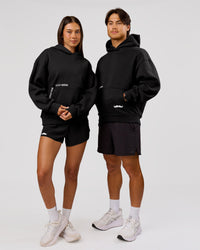 Man wearing Movember x LSKD Oversized Hoodie - Black | Model:George | Size:M | Thumbnail Index: 5
