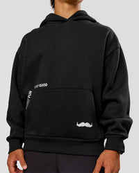 Man wearing Movember x LSKD Oversized Hoodie - Black | Model:George | Size:M | Thumbnail Index: 8