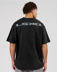 Man wearing Backline Washed Heavyweight Oversized Tee - Black Washed | Model:Leandro | Size:M | Thumbnail Index: 0