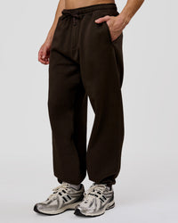 Man wearing Base Baggy Cuffed Track Pant - Ground Coffee | Model:Leandro | Size:M | Thumbnail Index: 0
