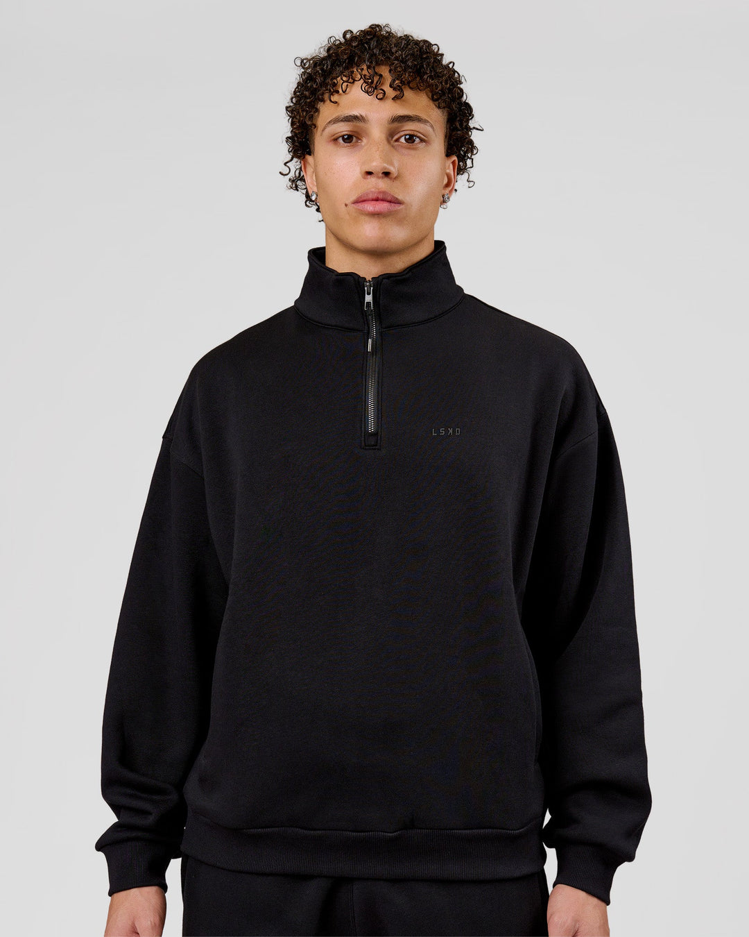 Man wearing Base Quarter Zip Sweater - Black | Model:Leandro | Size:M - view 1