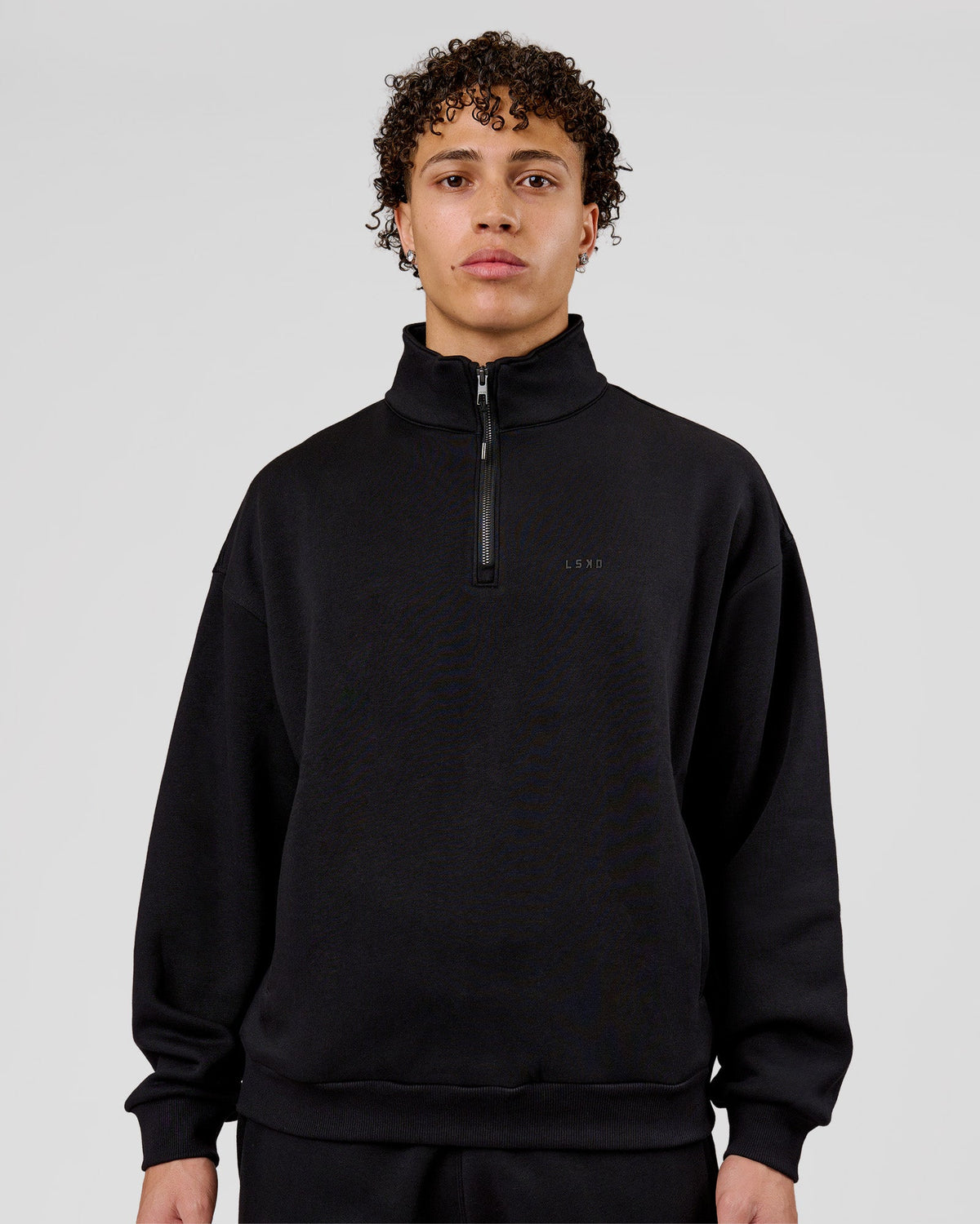 Man wearing Base Quarter Zip Sweater - Black | Model:Leandro | Size:M