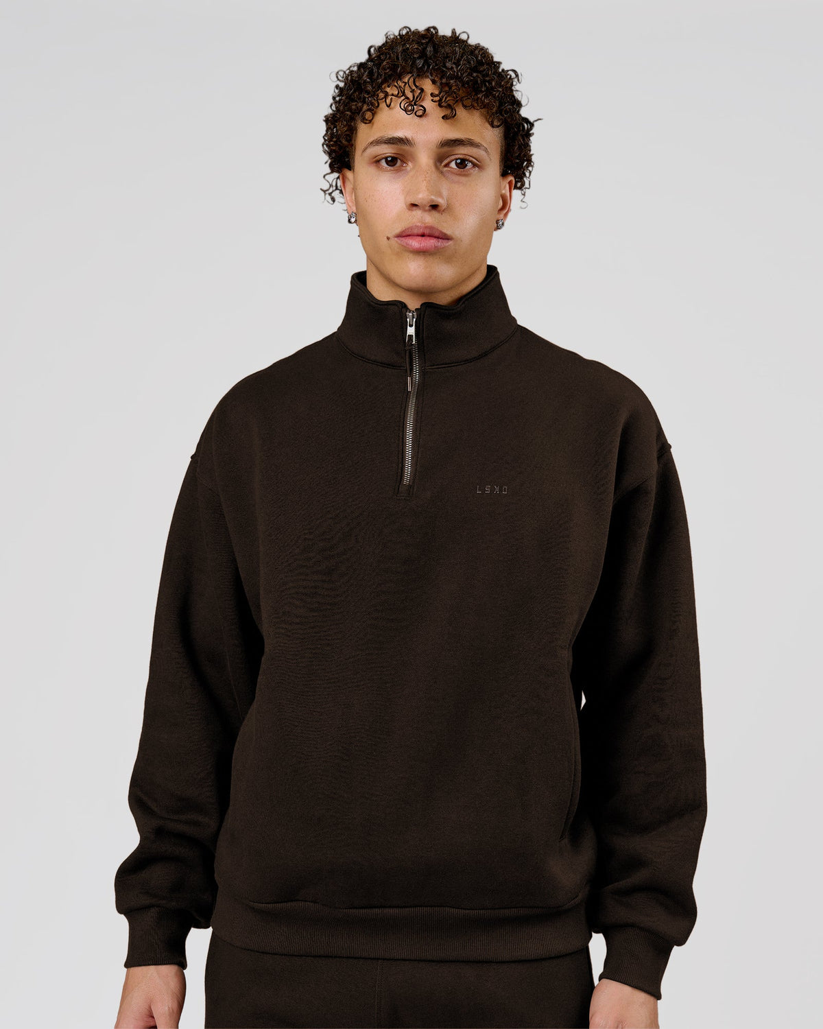Man wearing Base Quarter Zip Sweater - Ground Coffee | Model:Leandro | Size:M