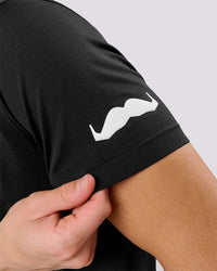 Man wearing Movember x LSKD Drive Seamless Polo - Black | Model:Leandro | Size:M | Thumbnail Index: 1