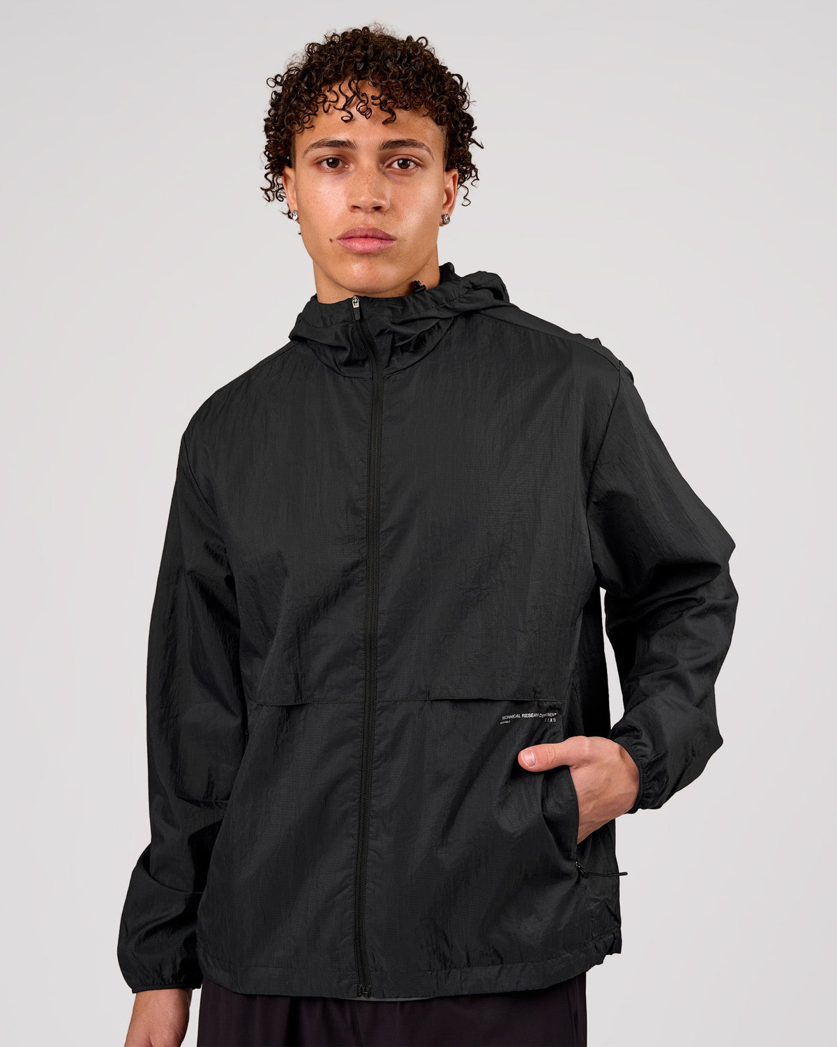 Man wearing Pace+ Lightweight Running Jacket - Black | Model:Leandro | Size:M - view 1