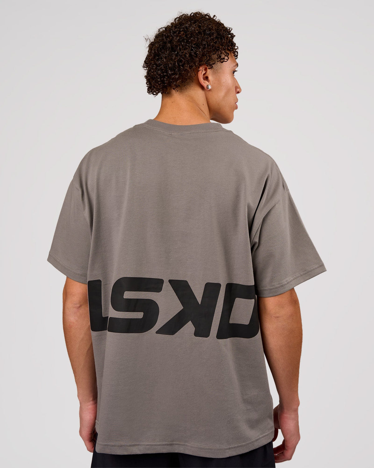 Man wearing Shadow Mark Heavyweight Oversized Tee - Storm Front-Onyx | Model:Leandro | Size:M
